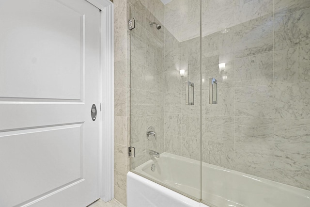 full bathroom with bath / shower combo with glass door