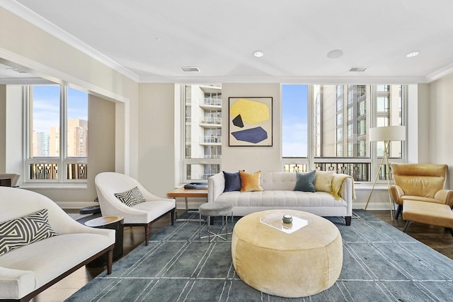 living room featuring visible vents, baseboards, dark wood-style flooring, and ornamental molding