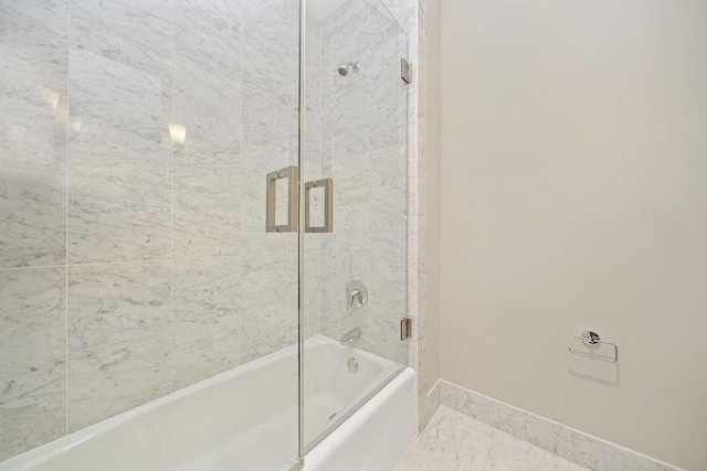 bathroom with shower / bath combination with glass door