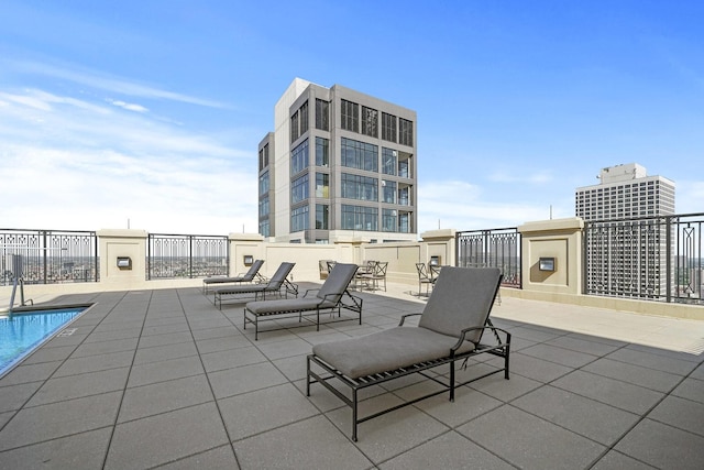 view of patio / terrace featuring a community pool and fence