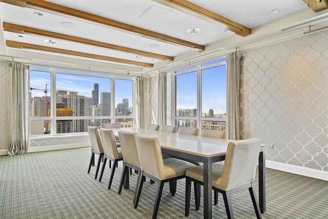 carpeted dining room featuring beamed ceiling, visible vents, baseboards, wallpapered walls, and a view of city