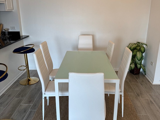 dining space featuring baseboards and wood finish floors