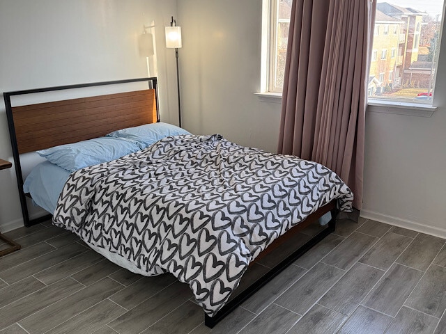 bedroom featuring baseboards and wood finish floors