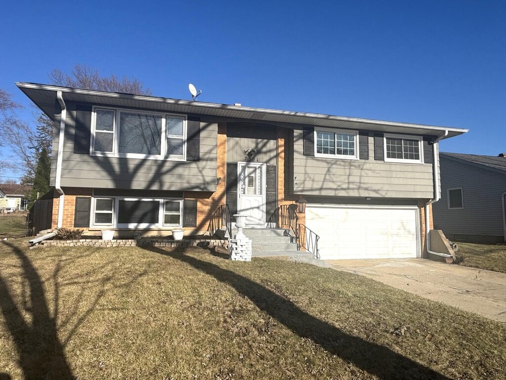 7351 Jasmine Dr, Hanover Park, IL 60133 - raised ranch featuring brick siding, concrete driveway, and an attached garage