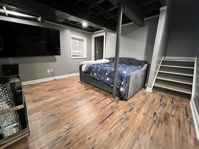 bedroom featuring wood finished floors and baseboards