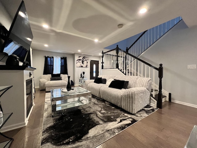 living area with recessed lighting, wood finished floors, and baseboards