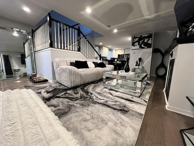 living area with stairway, recessed lighting, baseboards, and wood finished floors