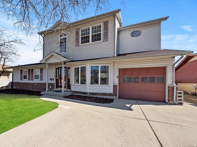 traditional-style house with a garage, a front yard, brick siding, and driveway