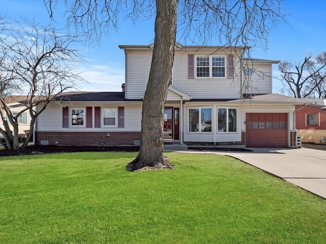 traditional-style home with brick siding, an attached garage, concrete driveway, and a front yard