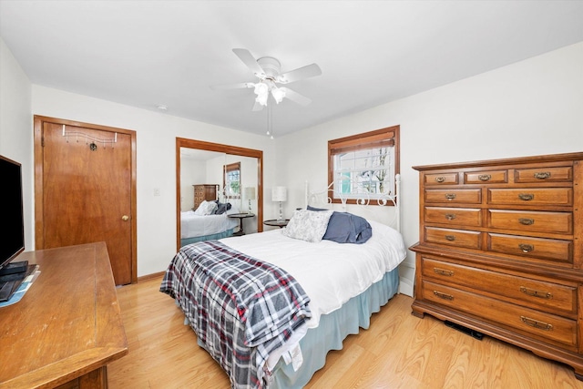 bedroom featuring baseboards, light wood-type flooring, and ceiling fan