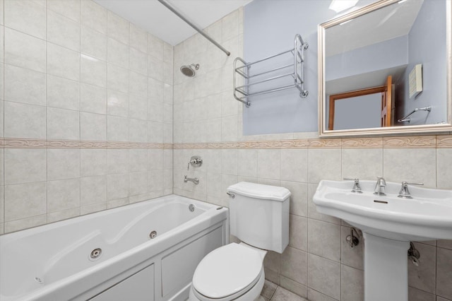 full bath featuring toilet, tile walls, and a combined bath / shower with jetted tub