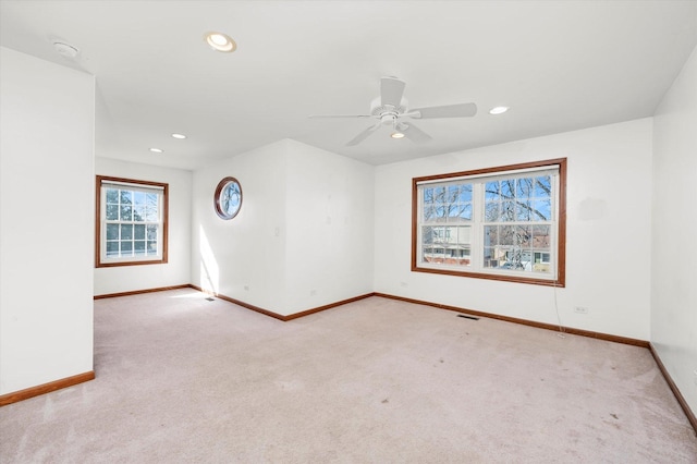 carpeted spare room featuring visible vents, recessed lighting, a ceiling fan, and baseboards