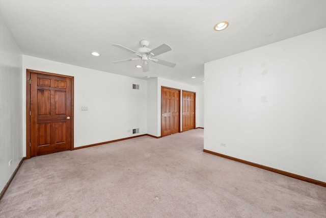 carpeted spare room featuring recessed lighting, baseboards, visible vents, and ceiling fan