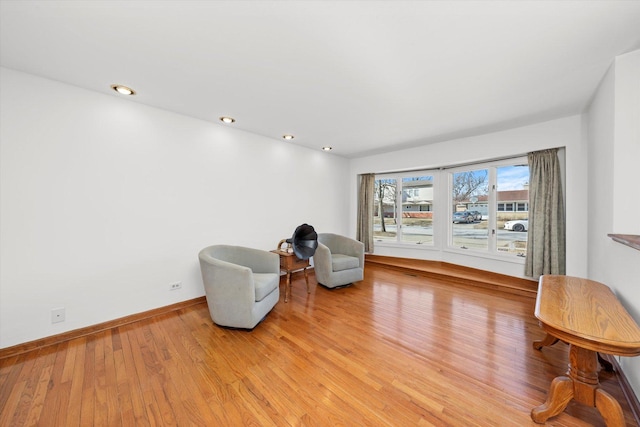 sitting room featuring recessed lighting, baseboards, and light wood-type flooring