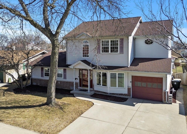 traditional-style home with brick siding, concrete driveway, an attached garage, and fence