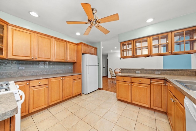 kitchen with white appliances, light tile patterned flooring, backsplash, and ceiling fan