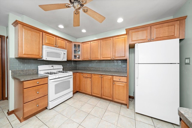 kitchen with a ceiling fan, backsplash, white appliances, light tile patterned floors, and glass insert cabinets