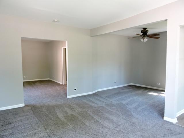 833 Pleasant St, Dekalb, IL 60115 - carpeted empty room with a ceiling fan and baseboards