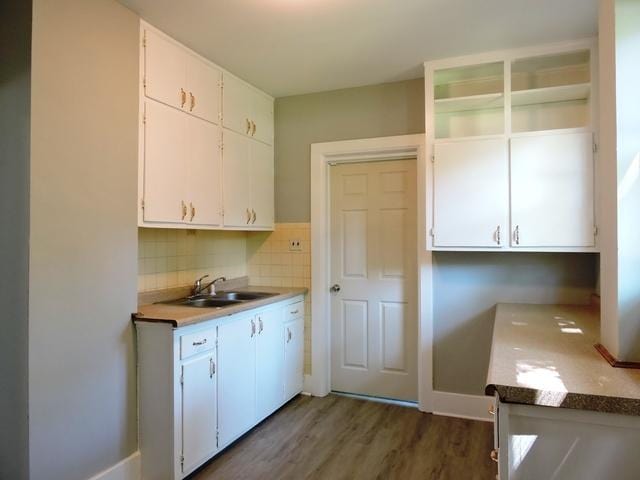 833 Pleasant St, Dekalb, IL 60115 - kitchen with a sink, white cabinetry, dark wood-type flooring, and tasteful backsplash