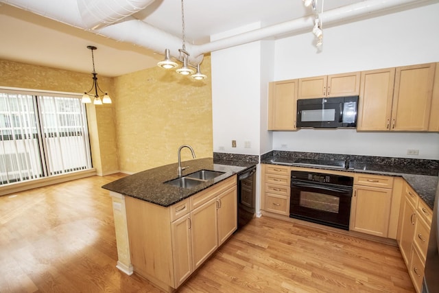 kitchen with light brown cabinets, a peninsula, light wood-style flooring, a sink, and black appliances