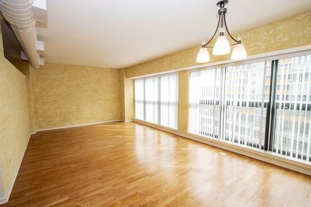 spare room with wood finished floors