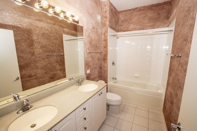 bathroom featuring tile patterned flooring, toilet, and a sink