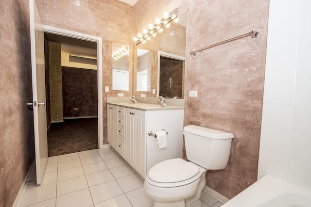 bathroom featuring tile patterned floors, toilet, tile walls, and a sink