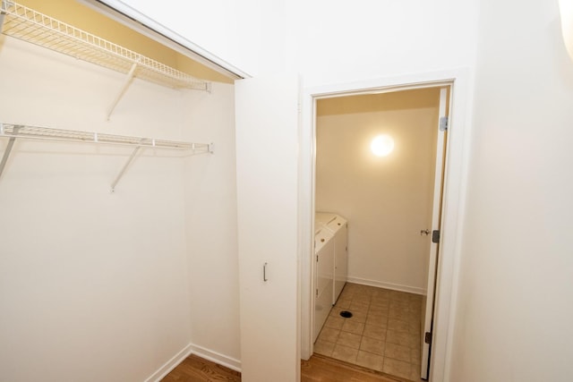 laundry area featuring baseboards and washing machine and clothes dryer