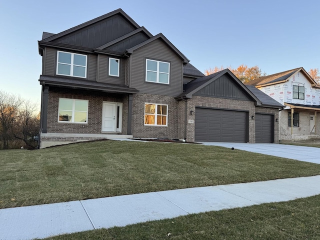 view of front of house with brick siding, board and batten siding, concrete driveway, a front yard, and an attached garage