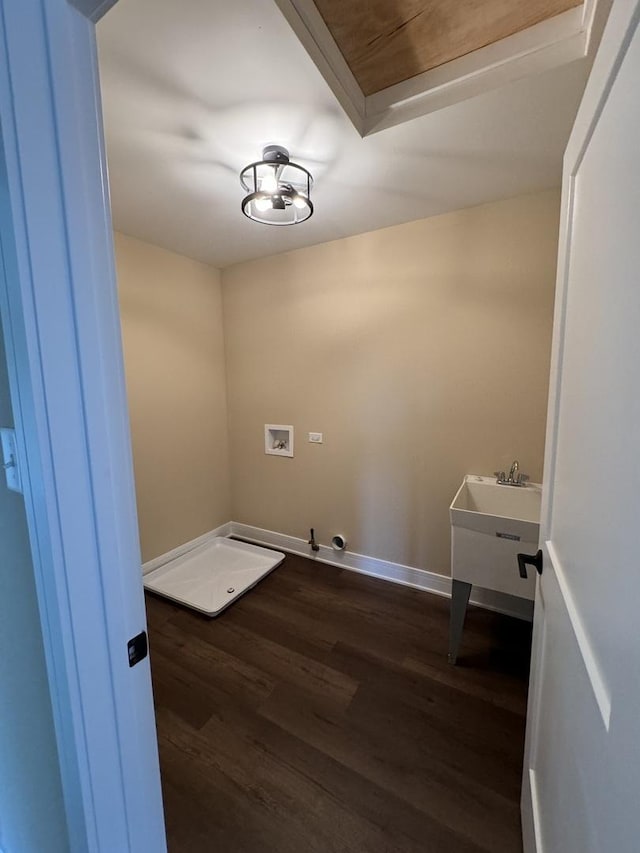 laundry area with dark wood finished floors, baseboards, gas dryer hookup, hookup for a washing machine, and laundry area