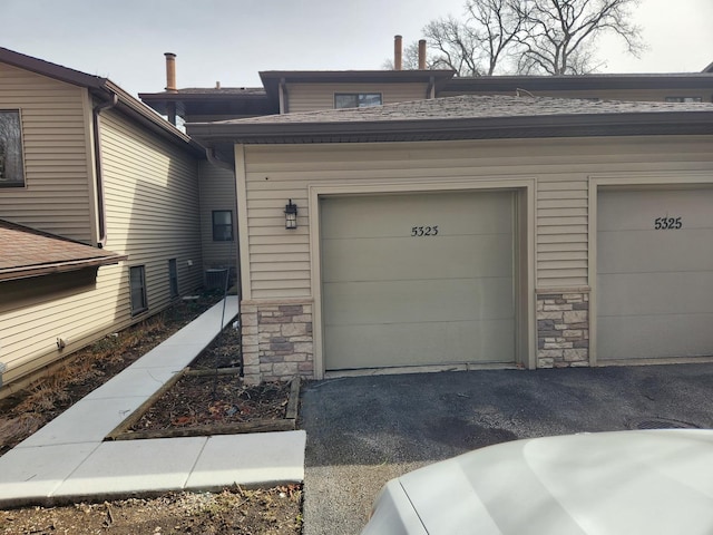 garage with aphalt driveway