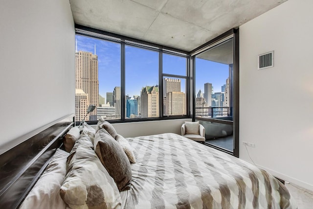 bedroom featuring a view of city, baseboards, and visible vents