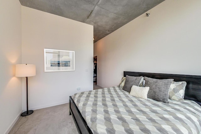 bedroom with light colored carpet and baseboards