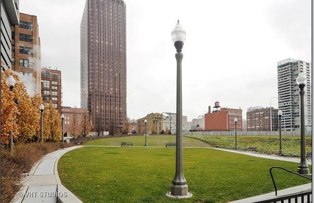 view of home's community with a yard and a city view