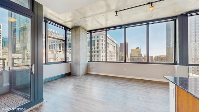 unfurnished sunroom featuring a city view