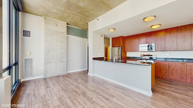 kitchen with visible vents, dark countertops, and appliances with stainless steel finishes