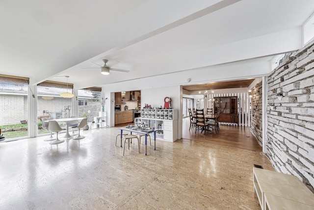interior space with ceiling fan with notable chandelier