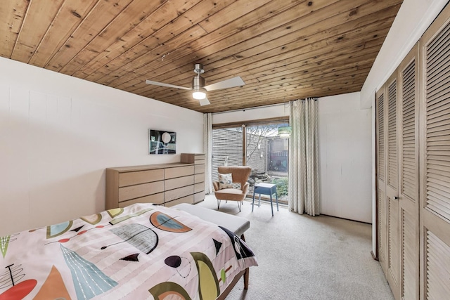 bedroom with a closet, wood ceiling, light carpet, and a ceiling fan