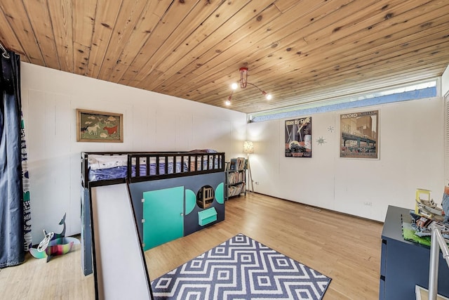 bedroom with wood ceiling and wood finished floors