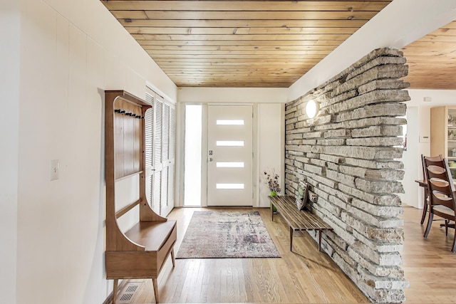 foyer entrance with wooden ceiling and light wood-type flooring