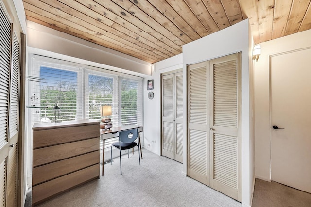 carpeted office space featuring wooden ceiling