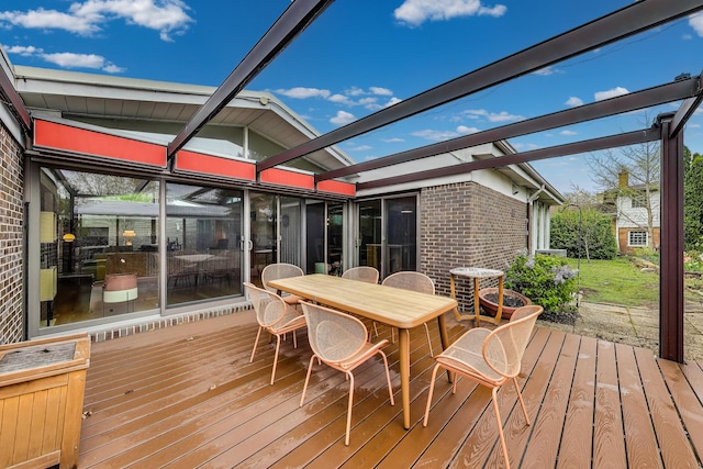wooden deck featuring outdoor dining area