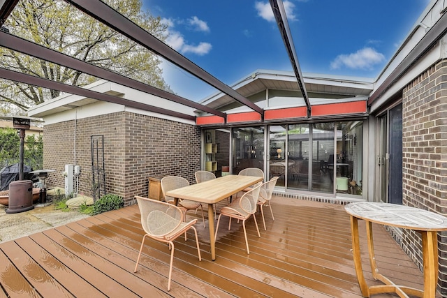 wooden terrace with outdoor dining space