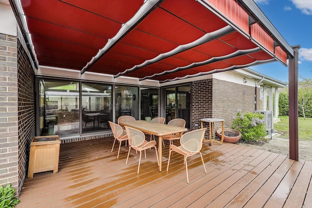 wooden terrace with outdoor dining space
