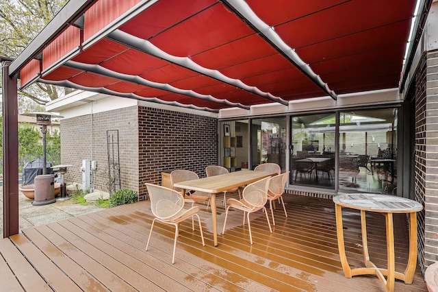 wooden terrace with outdoor dining space