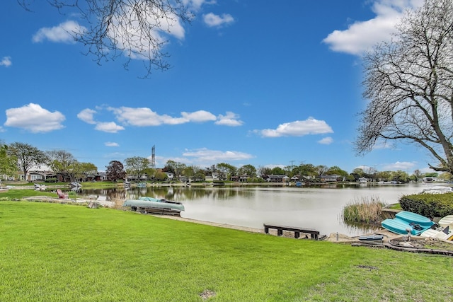 dock area with a water view and a lawn