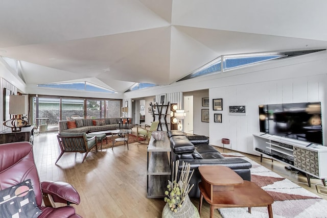 living area featuring wood finished floors and vaulted ceiling