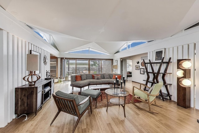 living area featuring lofted ceiling and wood finished floors