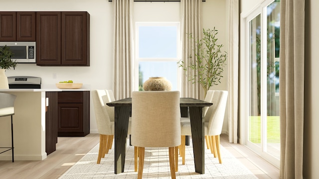 dining area with light wood-style floors