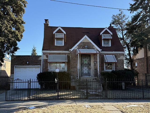 view of front of property featuring a fenced front yard, brick siding, and a chimney